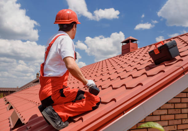 istock Man worker master in red overall and helmet is fixing the metal tile roof. 1404085573