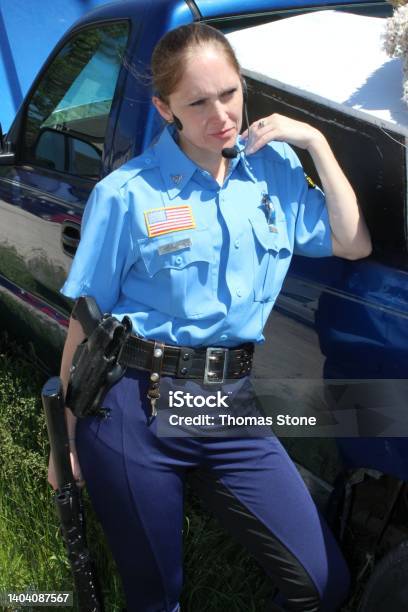 Female Officer Pulls Gun On Complying Male Lone Female Police Officer In Uniform Stock Photo - Download Image Now