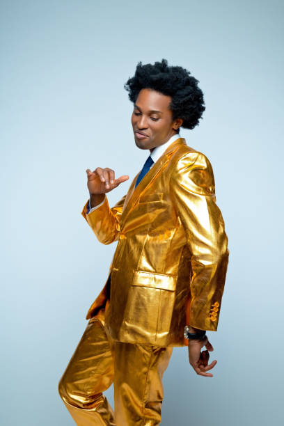 istock Man in golden suit enjoying dance 1404088967