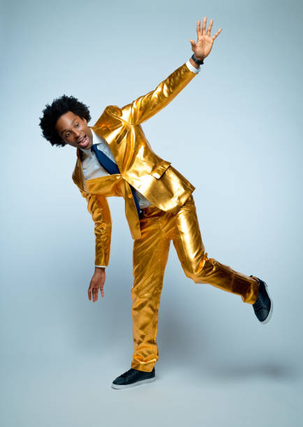istock Man in golden suit balancing on one leg 1404089081