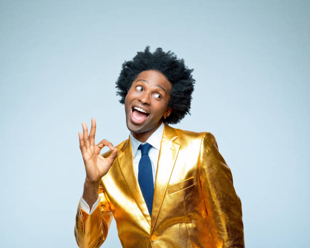 istock Man in golden blazer gesturing OK sign 1404089124