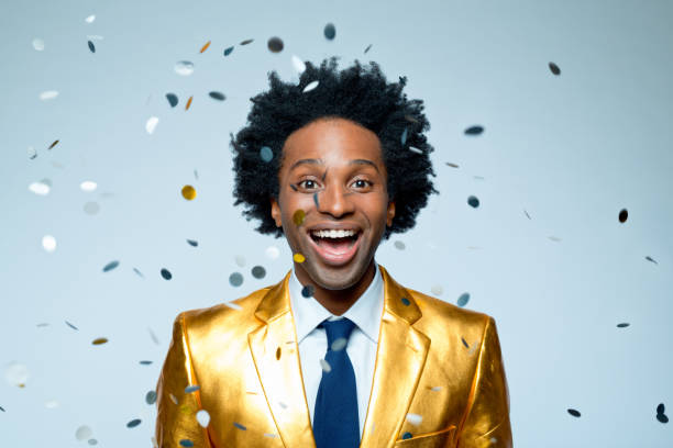 istock Man amidst confetti against blue background 1404089414