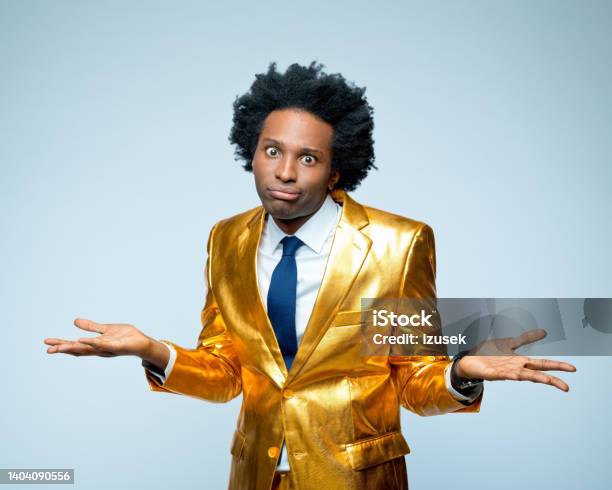 Confused Man Gesturing With Facial Expression Stock Photo - Download Image Now - Gold Colored, Making A Face, 30-34 Years