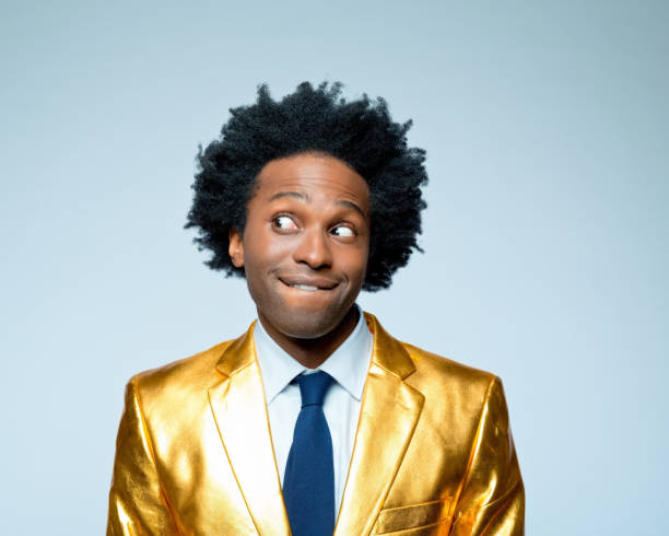 istock Businessman in golden blazer biting lip 1404091743