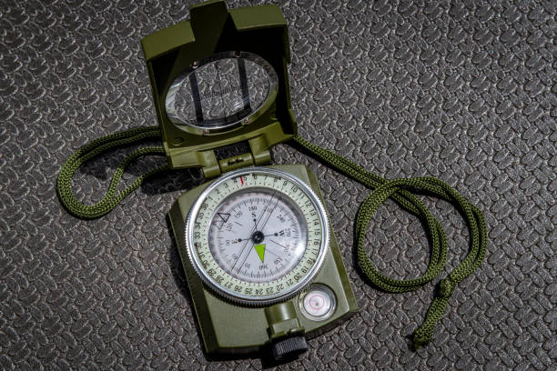 istock Nice military magnetic compass. On black  textured background 1404092292