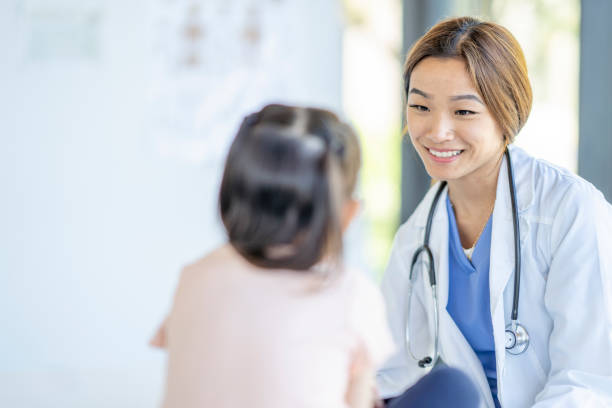 istock Doctor with a Young Patient 1404093050