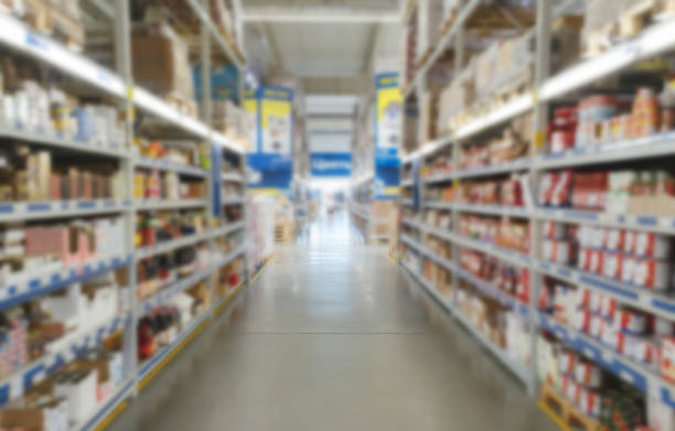istock Blurred supermarket aisle with colorful shelves of merchandise. Perspective view of abstract supermarket aisle with copy space in center, can use as background or retail concept 1404093473