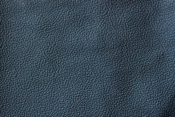 istock Texture of dark genuine leather close-up, granular texture 1404093572