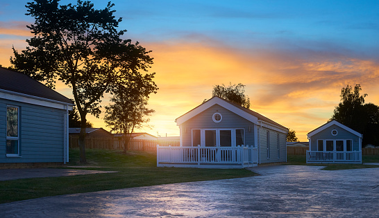 A row of holiday cabins at sunset
