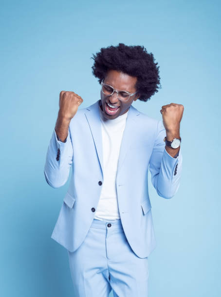 istock Successful man in blue blazer clenching fists 1404097068