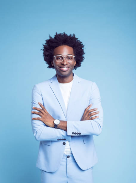 istock Smiling man in blue blazer with arms crossed 1404097087