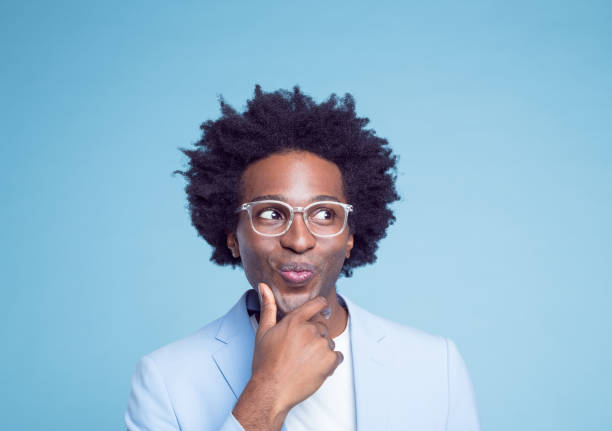 istock Smiling businessman with hand on chin 1404097615