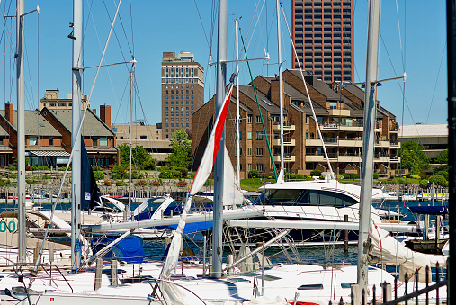 Buffalo, New York, USA - June 18, 2022: Office buildings rise skyward in the background of a residential condominium building located alongside the Erie Basin Marina.