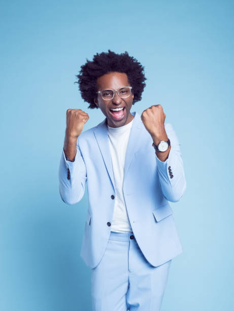 istock Happy man in blue blazer clenching fists 1404098364