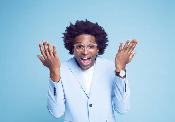 istock Happy businessman in blue blazer gesturing 1404098407