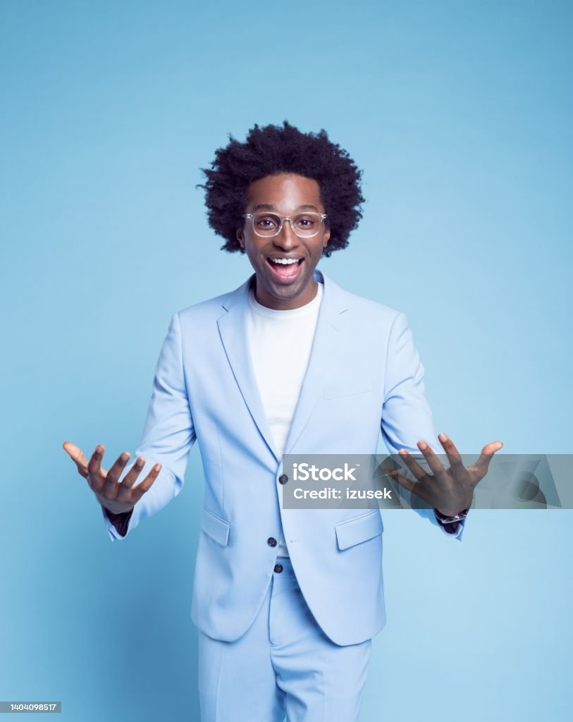 Happy businessman gesturing in blue blazer Portrait of happy businessman gesturing in blue blazer against colored background 30-34 Years Stock Photo