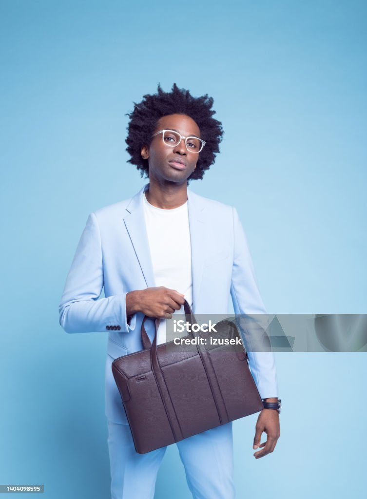 Confident man with briefcase Portrait of confident businessman in blue blazer with briefcase standing against colored background 30-34 Years Stock Photo