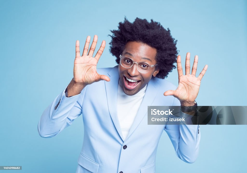 Cheerful man in blue blazer gesturing Portrait of cheerful businessman in blue blazer gesturing against colored background 30-34 Years Stock Photo