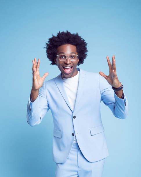 istock Cheerful businessman in blue blazer gesturing 1404099273