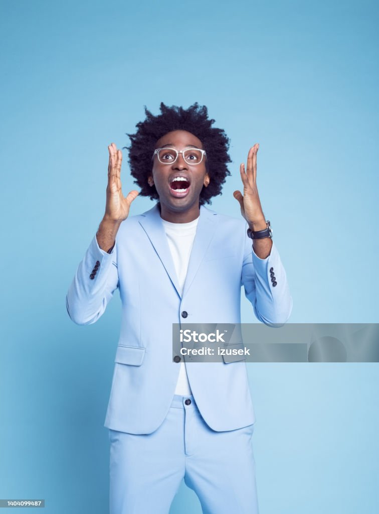 Angry man gesturing and shouting Angry businessman gesturing and shouting against blue background 30-34 Years Stock Photo
