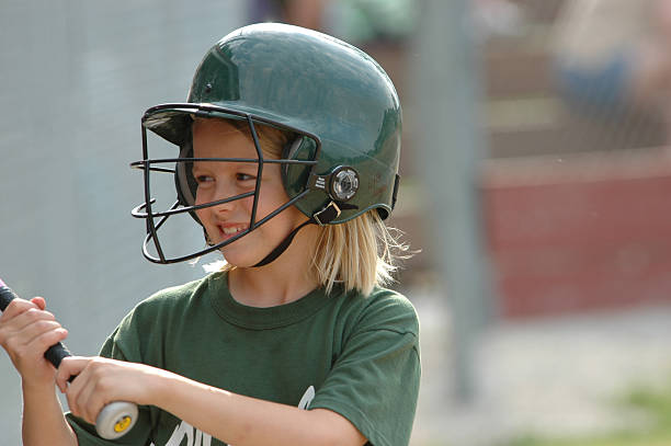 Distracted On Deck Young softball girl distracted on deck awaiting her turn at bat girl batting stock pictures, royalty-free photos & images