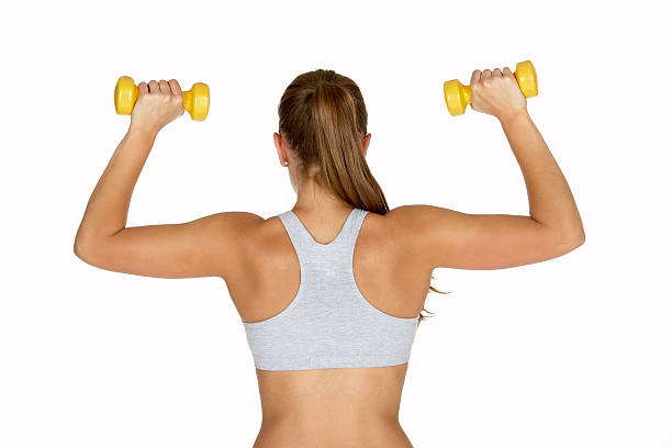 istock Beautiful Young Woman Holding Two Dumbbells with Back to Camera 140410062