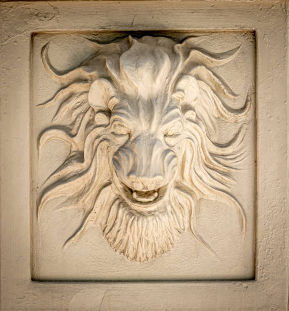 istock Tan Colored Lion Head Exterior Wall Decoration on Building Wall 1404101136