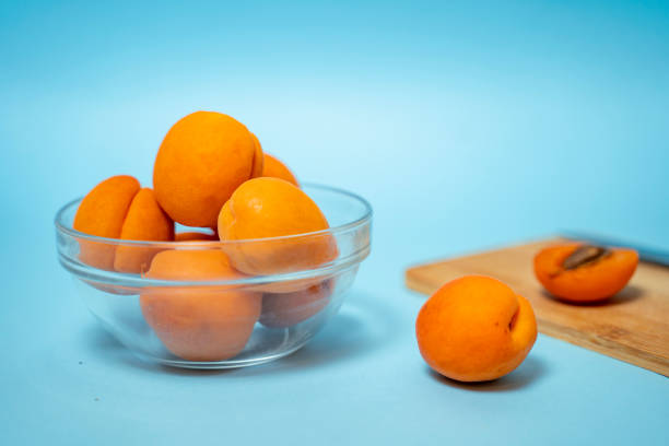 istock Healthy juicy apricots on blue background 1404103771