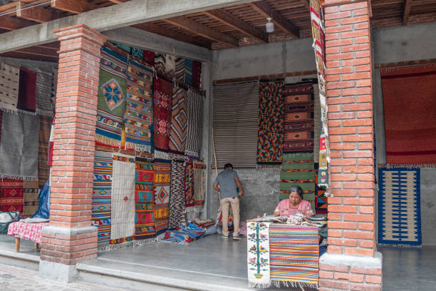 Teotitlan del Valle, Oaxaca, Mexico- May 23, 2022: Woman selling traditional handmade rugs in Teotitlan del Valle, Oaxaca, Mexico