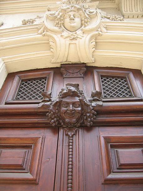 istock Two carved faces on a doorway 140410808