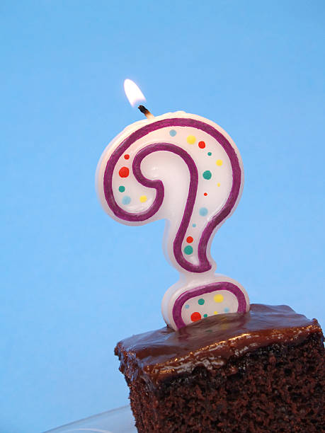 birthday cake with question candle stock photo