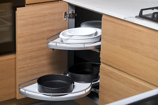 Kitchen access mechanism Magic corner for Blind Corner Cabinets. Solution for a kitchen corner storage in cupboard. Corner unit with pull out shelves, for cookware.