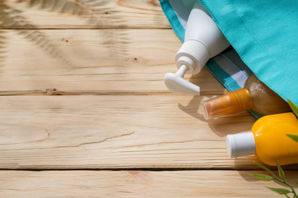 istock Sunscreen cream bottles in beach bag on wooden background 1404111070