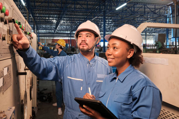 istock Industry engineers inspect machine control panels in manufacturing factory. 1404114580