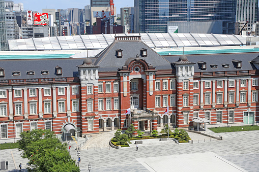 Tokyo Station is a railway station in Chiyoda, Tokyo, Japan.\nThe letters on the signboard in the photo are a note that you should get off the bicycle inside the station premises.