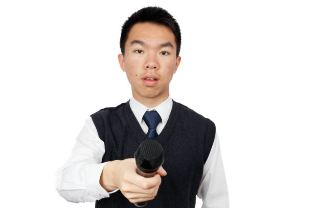 istock Young male reporter performing interview holding microphone 1404118920