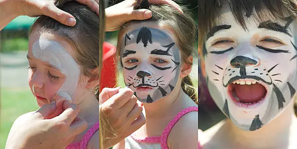 Young girl has her face painted with a cat. 3 images from first brush strokes to finished product. See the other in this series for additional choice - 
