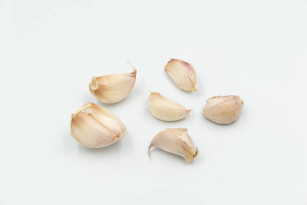 istock Isolated fresh raw garlic cloves on white background 1404121818