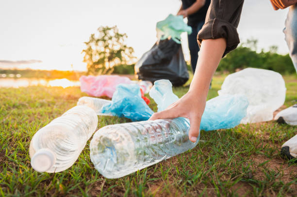 istock woman hand picking up garbage plastic bottle for cleaning at park 1404122269