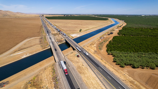 High quality stock photo of the California Aqueduct running through the heart of the Central Valley.  The Aqueduct covers about  440 miles from North to South yielding more than 650 million gallons of water a day.