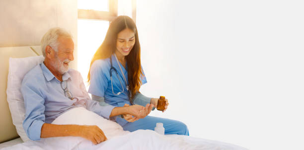 la enfermera está cuidando y dando medicamentos al anciano. - female nurse fotografías e imágenes de stock