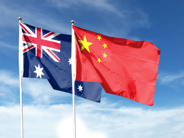 istock Australia and China flags with blue sky. waving blue sky 1404131312