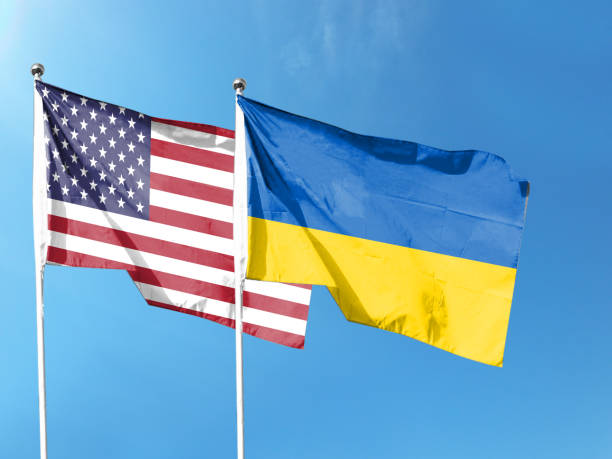 istock Ukrainian and American flags with blue sky. waving blue sky 1404131679