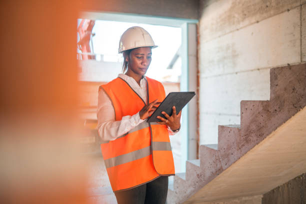 istock Black Mature Woman Supervising Construction Site 1404132724
