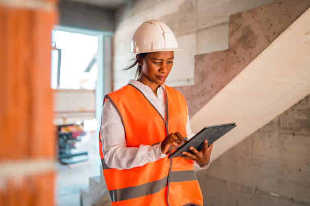 istock Black Mature Woman Supervising Construction Site 1404132737