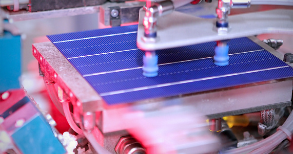 Closeup detail of a solar panel making machine.