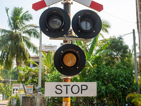 Hikkaduwa, Sri Lanka - March 4, 2022: Close-up of a traffic light at a railway crossing in Hikkaduwa.