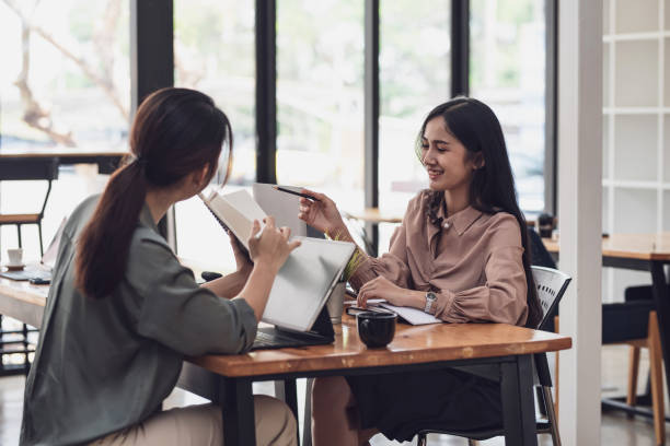 istock Two young Asian businesswoman is happy working on presentations using papers and tablet placed at the office. 1404135750