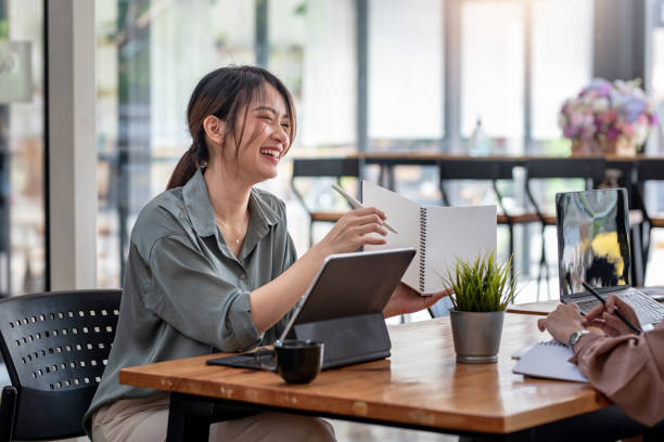istock Two young Asian businesswoman is happy working on presentations using papers and tablet placed at the office. 1404135753
