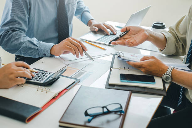 istock Business people brainstorm, discuss, plan and analyze business investment data graphs in meeting room. 1404135922